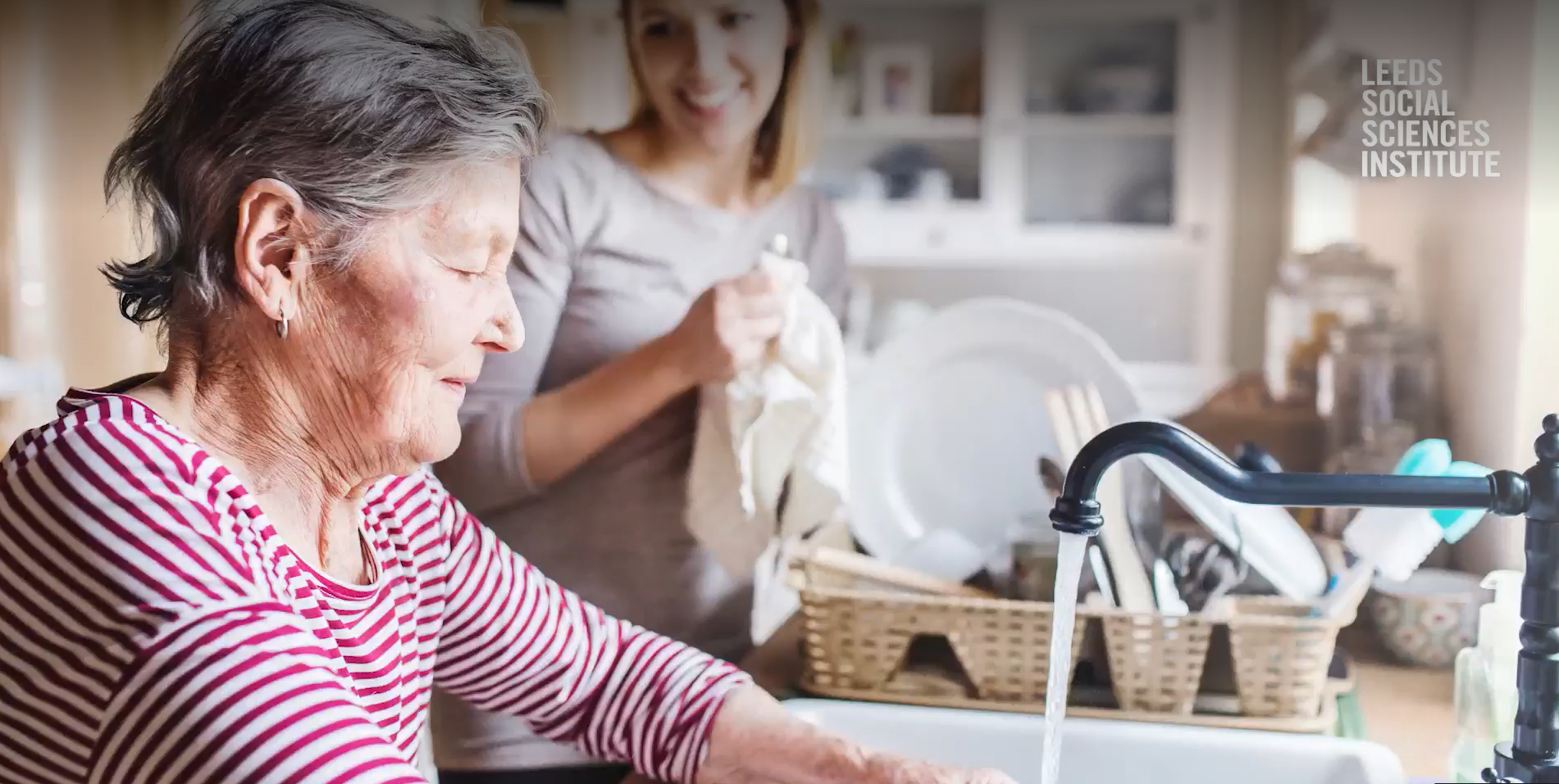 Elderly lady at a kitchen sink