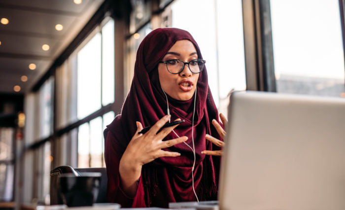 Woman talking to someone on a laptop