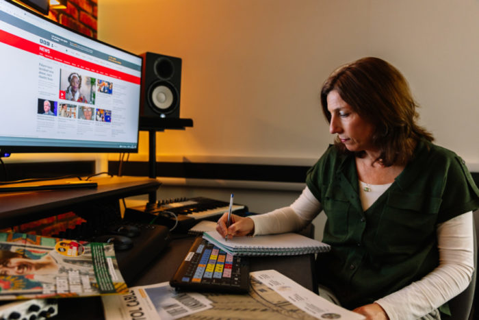 Photograph of Julie Firmstone working in a media suite