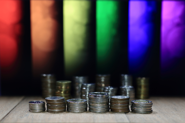Photograph representing LGBTQ+ economics colours and coins