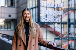 Photograph of Natalie Hopkins outside the Faculty of Biological Sciences