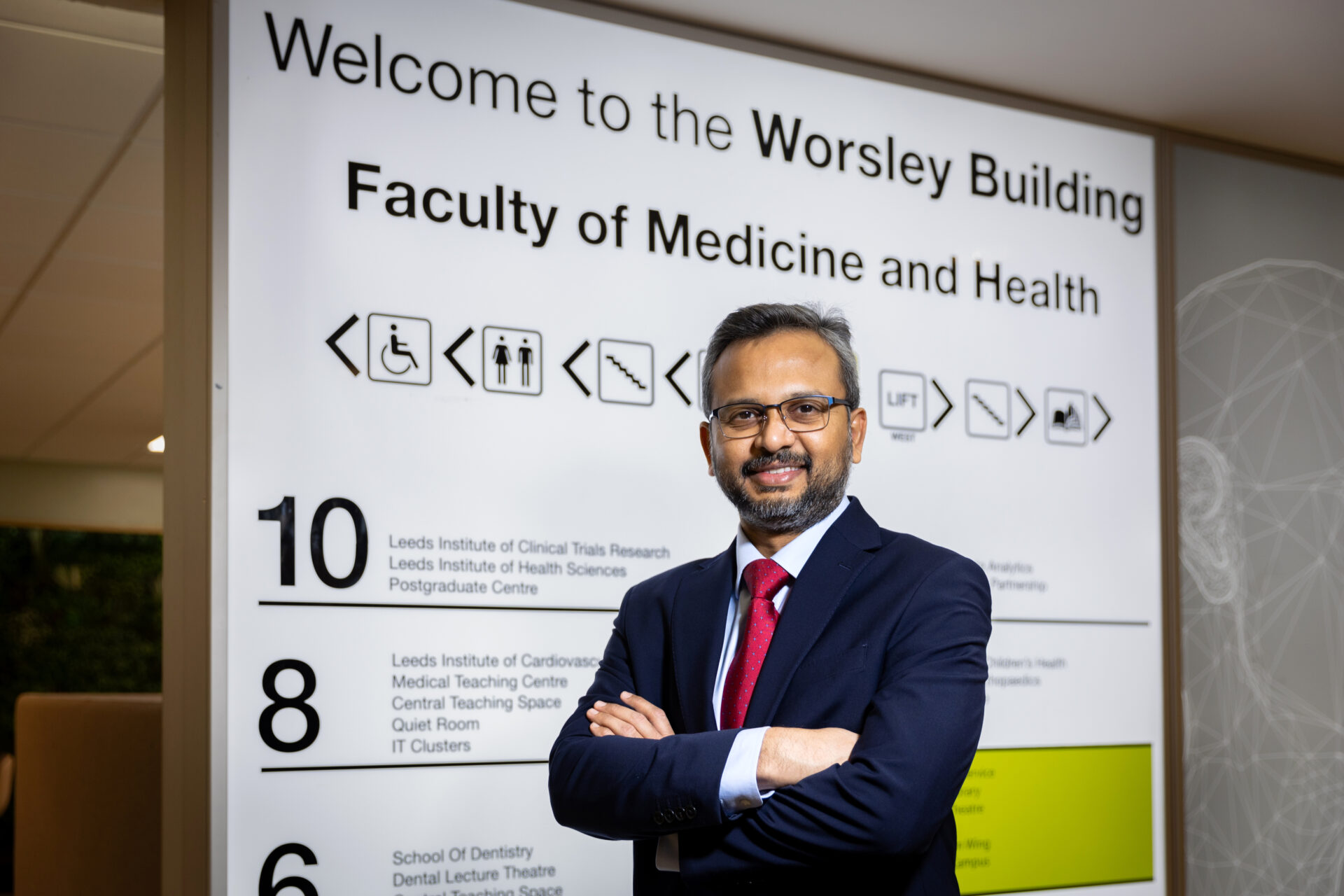 Manoj Sivan standing in front of the Worsley Building sign - School of Medicine